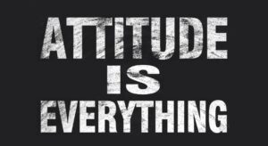 Attitude is everything text is written by white chalk on blackboard.